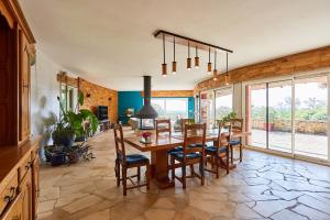 a dining room with a wooden table and chairs at les bois de saint auvent in La Geneytouse