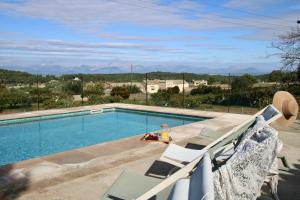a swimming pool with two lounge chairs next to it at MATER RANDA, piscina, vistas increíbles y barbacoa in Randa