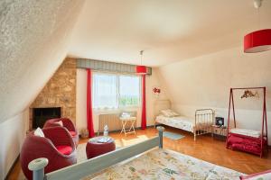 a living room with red furniture and a fireplace at les bois de saint auvent in La Geneytouse +28 photos