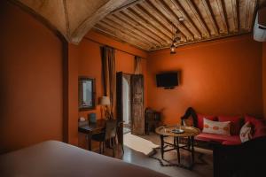 a living room with a couch and a table at Riad Le Rihani in Marrakesh