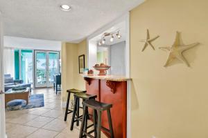 a kitchen and living room with stars on the wall at Oceanfront condo with direct beach access, pool, balcony, grilling area, & AC in Fernandina Beach
