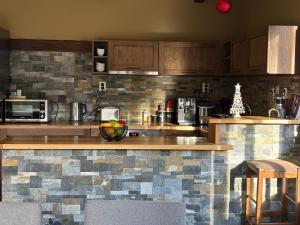 a kitchen with a counter with a bowl of fruit on it at Къща за гости Гергана in Ribarica +22 photos