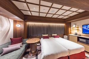 a bedroom with a large bed and a couch at Hotel Keihan Asakusa in Tokyo