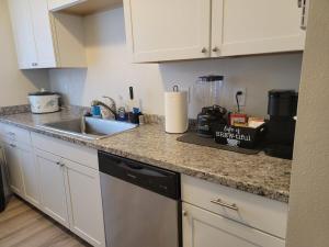 a kitchen with a sink and a counter top at Close to everything in Tacoma! in Tacoma