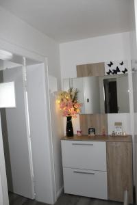 a kitchen with a counter and a vase of flowers at Gemütliche Wohnung in Mendig in Mendig