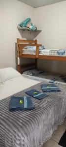 a bed with two bunk beds with towels on it at Pousada Canto dos Passaros in Chapada dos Guimarães +175 photos