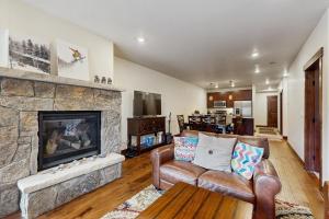 a living room with a couch and a fireplace at Blue River Retreat in Silverthorne