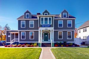 a blue house with a sign on the front of it at Steps to Holyoke Medical Center! Remote-Work Hub in Holyoke