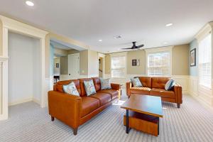 a living room with two couches and a table at Steps to Holyoke Medical Center! Remote-Work Hub in Holyoke