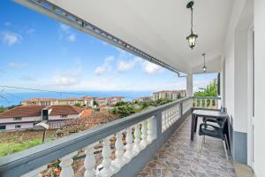 a balcony with a view of the ocean at Caniço Seaview House in Caniço
