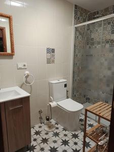 a bathroom with a toilet and a sink and a shower at Apartamento Turístico Dalmacia AT-CC-00769 in Gata +8 photos