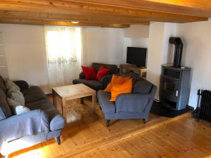 a living room with two couches and a wood stove at Casa Onsernone in Comologno in Comologno