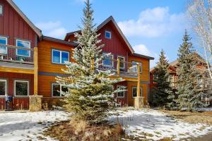 a house with a christmas tree in front of it at Blue River Retreat in Silverthorne
