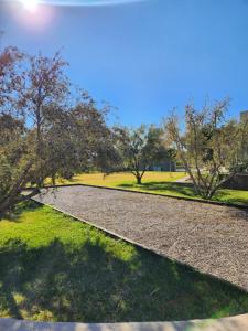 a walkway in a park with trees and grass at Atlas villa c3 in Sraghna +13 photos