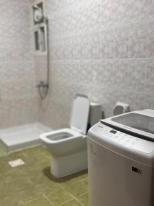 a bathroom with a toilet and a shower in it at أجاويد 1 Ajaweed in Salalah