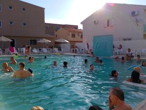 a group of people in a swimming pool at Marechal Plaza Hotel in São Gabriel