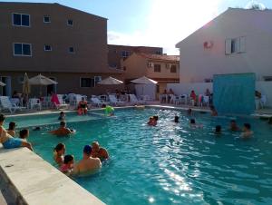a group of people in a swimming pool at Marechal Plaza Hotel in São Gabriel
