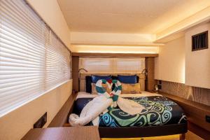 a bedroom with a bed with towels on it at Akula Catamaran - N4 Charters Seychelles in Victoria