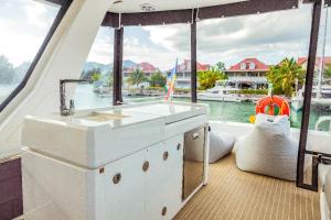 a kitchen on a boat with a large window at Akula Catamaran - N4 Charters Seychelles in Victoria +23 photos