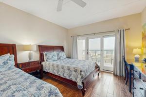 a bedroom with two beds and a balcony at Ocean Front Hotel Side Condo with Balcony, WiFi & Shared Pool in Fernandina Beach +26 photos