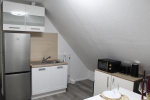a kitchen with a sink and a refrigerator at Gemütliche Wohnung in Mendig in Mendig