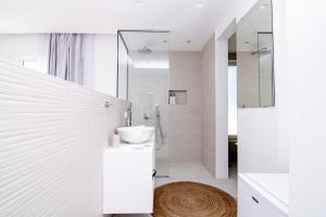 a white bathroom with a sink and a shower at serene villas in Ierapetra +43 photos