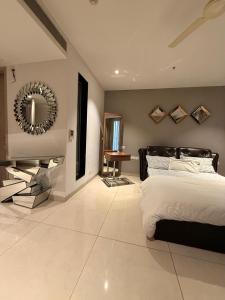 a bedroom with a bed and a mirror on the wall at Luxury Studios Key 1 in Gurgaon