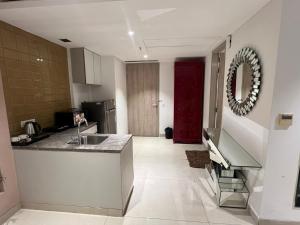 a kitchen with a sink and a red door at Luxury Studios Key 1 in Gurgaon