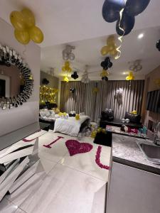 a living room with a table and balloons on the floor at Luxury Studios Key 1 in Gurgaon +2 photos