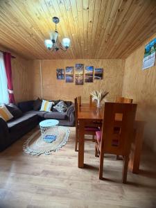 a living room with a couch and a table at Cabaña A & M in Chaitén