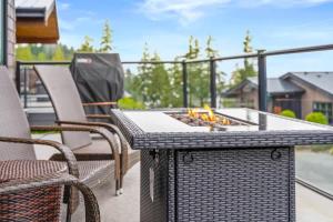 a fire pit on a patio with chairs and a grill at Wild Beauty - Oceanview - Pet Friendly - sleep 2 in Port Renfrew