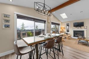 a dining room and living room with a table and chairs at Wild Beauty - Oceanview - Pet Friendly - sleep 2 in Port Renfrew