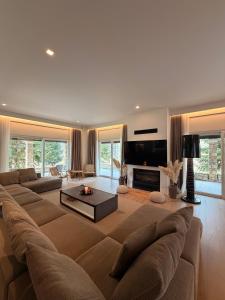 a large living room with a large couch and a fireplace at eleni's villa in Kandhíla