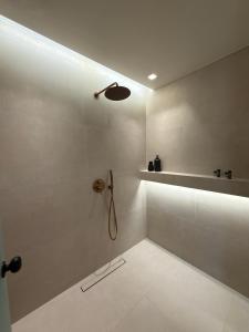 a bathroom with a shower with a shower head at eleni's villa in Kandhíla