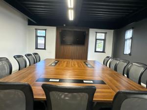 a conference room with a large wooden table and chairs at Hotel Corona Plaza in Rosarito +17 photos