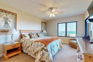 a bedroom with a bed and a window at Oceanfront condo with panoramic views, shared pool, and private washer & dryer in Fernandina Beach +39 photos