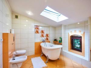 a bathroom with a tub and a toilet and a sink at Large holiday home, summer pool, sauna, whirlpool in Sasino +40 photos