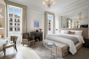 a bedroom with a bed and a desk and a fireplace at The St. Regis Rome in Rome +188 photos