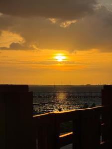 a sunset over the ocean with the sun setting at Pousada Rio Aratuá in Galinhos +66 photos