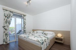 Posteľ alebo postele v izbe v ubytovaní Paradis Apartments + 37 fotografií