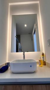 a bathroom with a sink and a mirror at Nuevo y moderno departamento Quito Norte in Quito