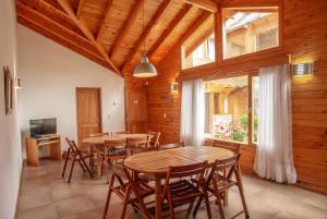 a dining room with wooden tables and chairs at Apart del Faldeo in San Martín de los Andes