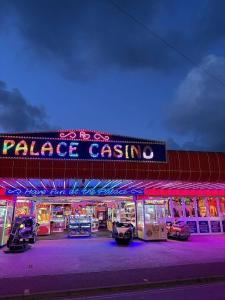 a palace casino with cars parked outside at night at 192, Two bed newly refurbished chalet on Sund0wner Holiday Park - Sleeps 5, pet friendly - Includes electricity, bed linen and towels - Entertainment options close by in Hemsby