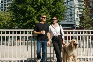 a man and a woman walking a dog at SoHo Hotel Toronto in Toronto +31 photos