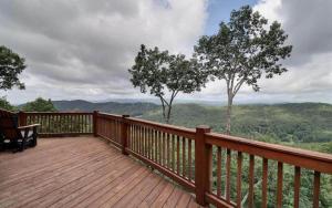 a wooden deck with a view of the mountains at Majestic Mountaintop Escape in Blue Ridge