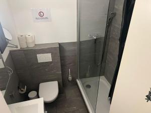 a small bathroom with a shower and a toilet at Central Living Brugg - Studio 11 in Brugg