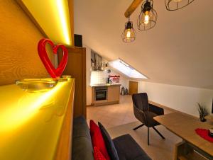 a living room with a heart decoration on a counter at Ferienhaus Alexandra in Nesselwang