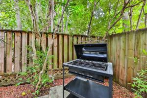 a black piano sitting on a table next to a fence at Garden botanical Villa with jacuzzi in Hollywood
