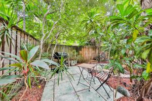 a garden with a fence and a table and chairs at Garden botanical Villa with jacuzzi in Hollywood +52 photos