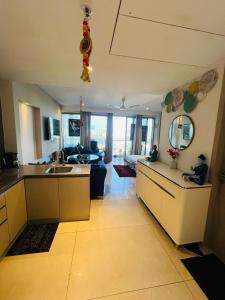 a kitchen and living room with a sink and a couch at Luxury Studios Key 7 in Gurgaon